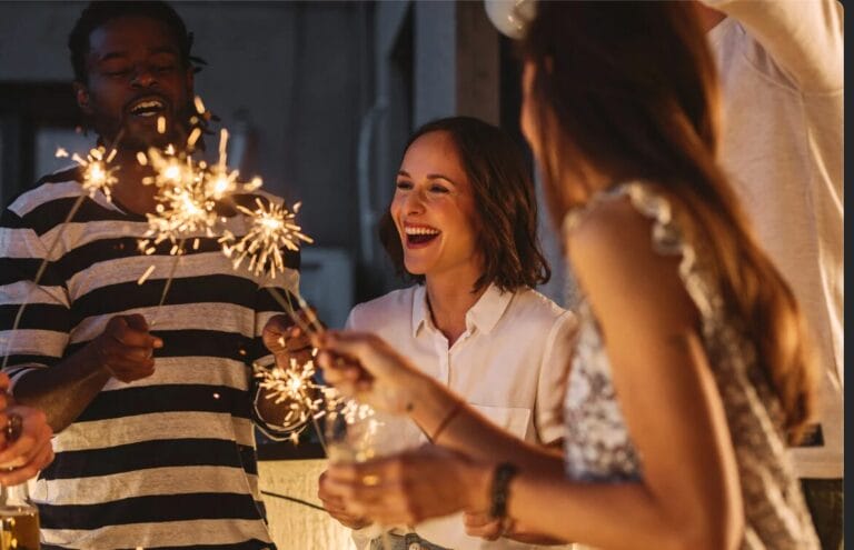 People celebrating New Year's holding sparklers